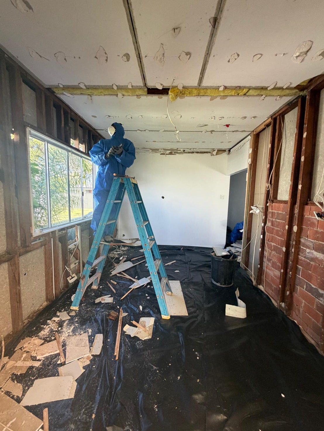 Interior room at early stage of asbestos removal with ladder