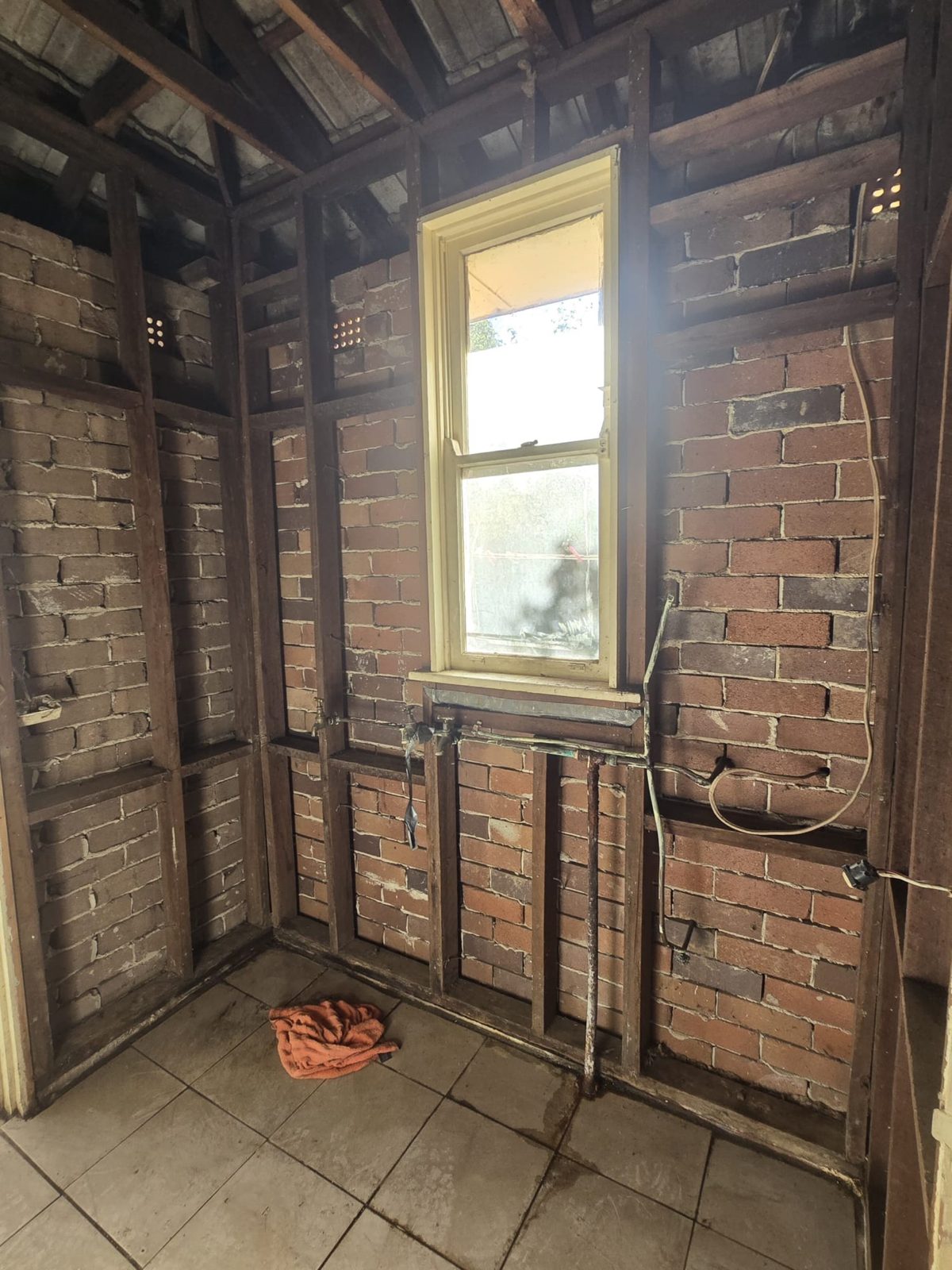 Brick wall with timber framing and yellow window frame